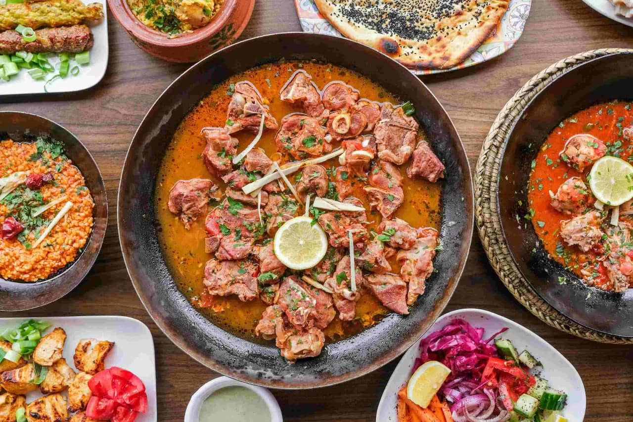 Pakistani karahi and other dishes on a dining table